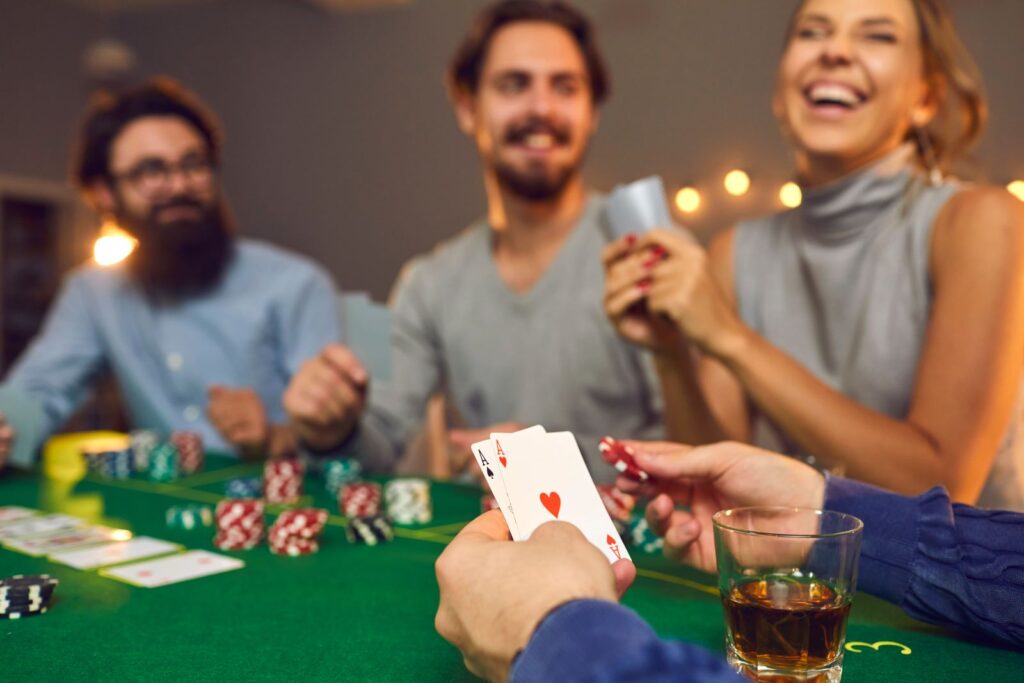 people enjoying drinks and a poker game