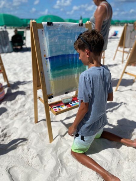 kid painting on the beach
