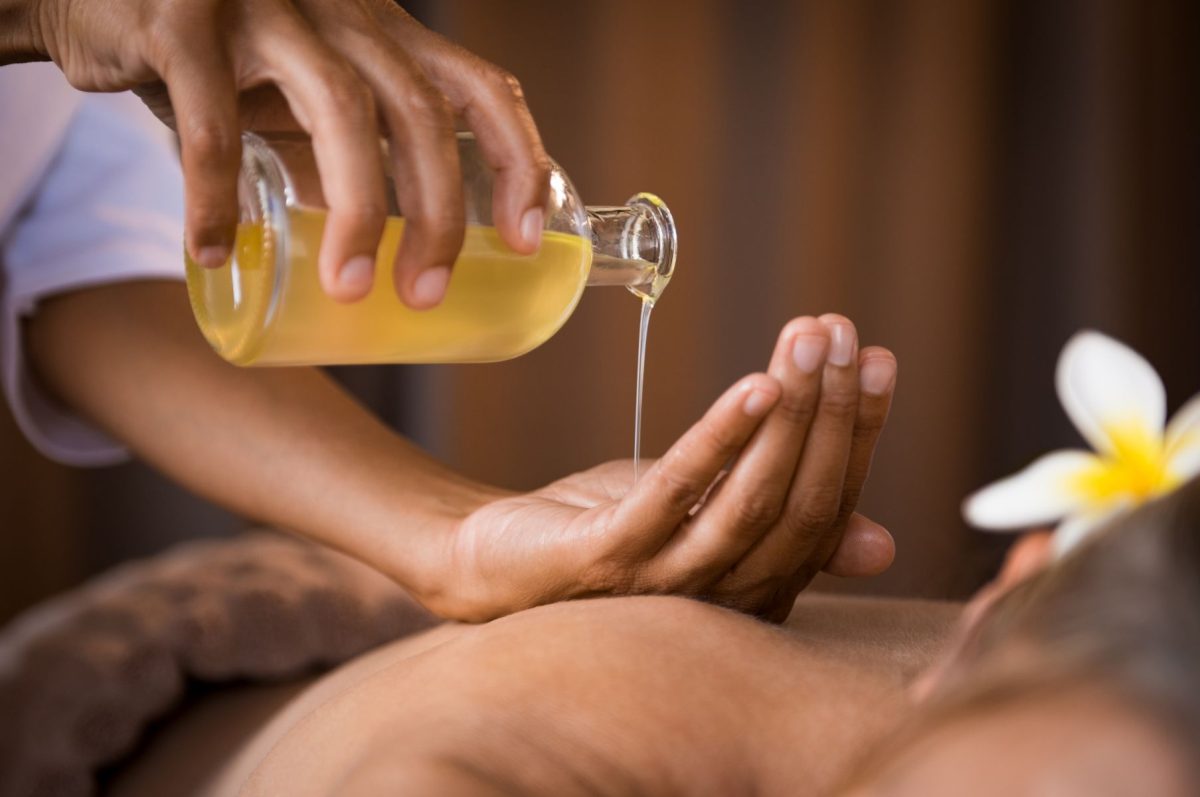 Massage oil being poured into hand