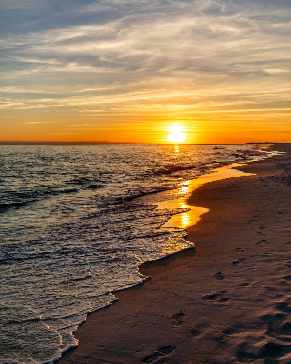 Sunset over the water on the beach